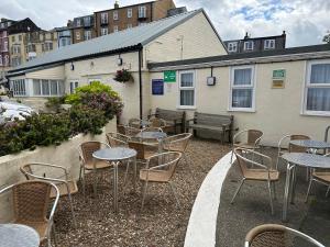 a group of tables and chairs in front of a building at Clifton Hotel in Scarborough