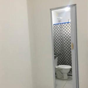 a bathroom with a toilet and a shower at Apartamento Confortável in Natal +20 photos