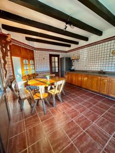 a kitchen with a table and chairs in a room at Villa Natalia in La Zarzuela