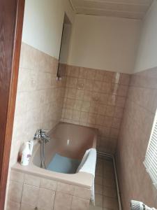 a bath tub in a bathroom with a sink at Maison LES 3 ROSES in Wolfisheim