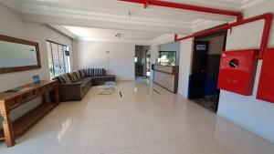 a living room with a couch and a table at Hotel Blue Star II in Foz do Iguaçu