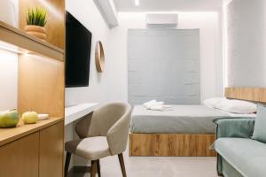 a small bedroom with a bed and a chair at DEMs central stay Volos with private parking in Volos