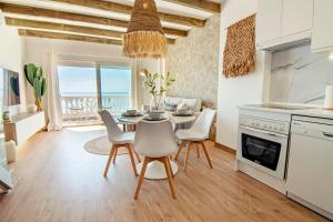 a kitchen and dining room with a table and chairs at Mara's Apartments Torremolinos SeaViews -Beachfront - Duplex Penthouse in Torremolinos