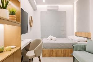 a small room with a bed and a chair at DEMs central stay Volos with private parking in Volos