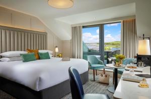 a hotel room with a large bed and a balcony at Westport Coast Hotel in Westport