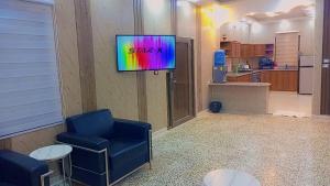 a living room with a tv on a wall at شقه مفروشه للايجار و بيت مزرعة مفروشه للايجار in Jerash
