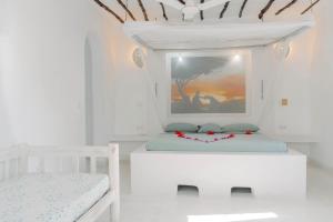 Postel nebo postele na pokoji v ubytování Baobab Village + 37 fotografií