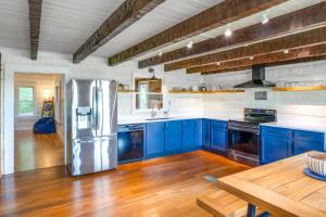 a kitchen with blue cabinets and a stainless steel refrigerator at about 10 Mi to Downtown Murfreesboro Area Cabin in Lascassas