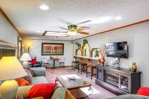 a living room with a couch and a fireplace at Bull Shoals Lake Home at Beaver Creek Marina! in Kissee Mills