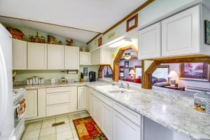 a kitchen with white cabinets and a counter top at Bull Shoals Lake Home at Beaver Creek Marina! in Kissee Mills