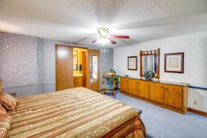 a bedroom with a bed and a dresser at Bull Shoals Lake Home at Beaver Creek Marina! in Kissee Mills