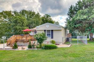 a small house with a deck and a fence at Bull Shoals Lake Home at Beaver Creek Marina! in Kissee Mills