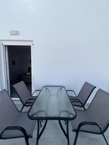 a group of chairs and a table in a room at Anemos Naxos town suites-apartment in Naxos Chora