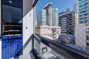 a view of a city from a building balcony at Apto c/ varanda a 150m do mar em Meia Praia RCB405 in Meia Praia