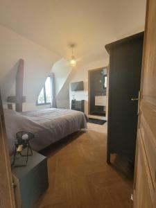a bedroom with a bed and a large window at Villa NICAISE in Moisenay