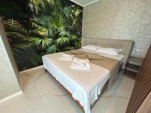 a bedroom with a bed with towels on it at TUDOR BY DEDAL APARTHOTEL in Năvodari +45 photos