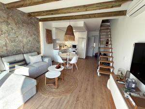 a living room with a couch and a table at Mara's Apartments Torremolinos SeaViews -Beachfront - Duplex Penthouse in Torremolinos