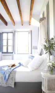 a bedroom with a large white bed with a window at Villa Station by Cassai in Ses Salines