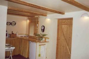 a kitchen with a counter and a wooden door at Nilseni in Jelgava +31 photos