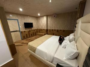 a bedroom with a large bed and a television at Parakkat Nature Resort in Munnar