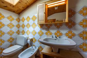 a bathroom with a sink and a toilet and a mirror at MAISON MOULIN - Relax e vista Montagna - LA THUILE 0107 in La Thuile
