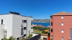 a view of a city with buildings and the water at Apartman Luna in Trogir