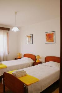a hotel room with two beds and two tables at Flat Accommodation in Braga in Braga