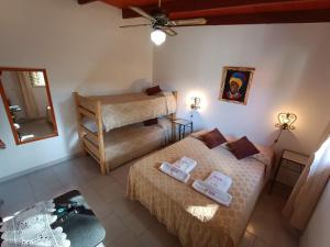 a small room with two beds and a mirror at Castelar - Hotel & Apart in Huerta Grande +82 photos