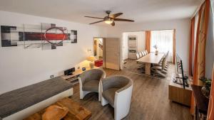 a living room with a bed and a dining room at Ferienhaus City Ferienhaus Daun in Daun