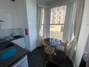 a kitchen with a table and chairs and a window at Farina No2, Sea view apartment sleeping 4 guests in Bridlington