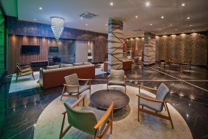 a lobby with chairs and a table and a couch at Edifício Time Acomodações in Maceió +267 photos