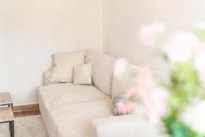 a white living room with a couch and a table at Appartement unique - Centre ville in Chambéry +18 photos