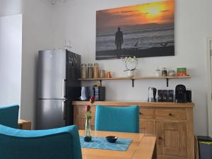 a kitchen with a dining table and a refrigerator at Victorian Renovation Room 1 in Liverpool