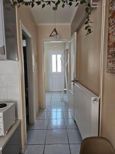 a hallway of a home with a door and a tile floor at Platsa Studios in Megás Limniónas