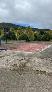 an empty basketball court with a basketball hoop at Pensión montoxo in Cedeira
