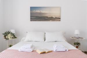 a bedroom with a bed with a book and towels at Rincón de Lucia Cenes de la Vega in Cenes de la Vega