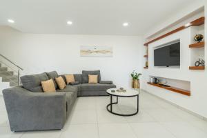 a living room with a couch and a table at Casa Antonette, Lovely house with a pool in Calheta