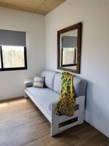 a living room with a couch and a mirror at Jose Ignacio in José Ignacio +13 photos