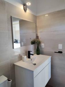 a white bathroom with a sink and a mirror at Jose Ignacio in José Ignacio