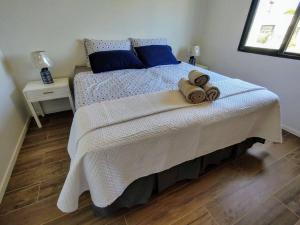a bedroom with a bed with towels on it at Jose Ignacio in José Ignacio