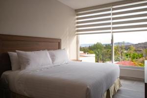 Katil atau katil-katil dalam bilik di Memora Hotel & Villas Chapala