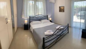 a bedroom with a bed with two towels on it at Vagias Home in Kanali