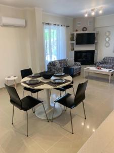 a living room with a table and chairs and a couch at Vagias Home in Kanali