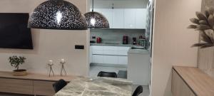 a kitchen and dining room with a table and chairs at Kallia Sea Breeze - 3 Bedroom Apartment in Rhodes Town +23 photos