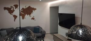 a living room with two pendant lights and a television at Kallia Sea Breeze - 3 Bedroom Apartment in Rhodes Town