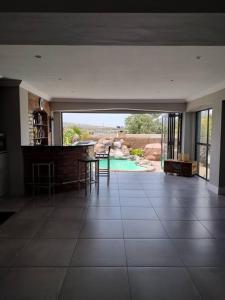 a large living room with a view of a pool at Champers with a view in Cape Town