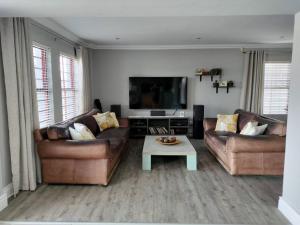 a living room with two couches and a coffee table at Champers with a view in Cape Town