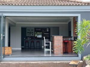 an outdoor kitchen with a bar in a house at Champers with a view in Cape Town +27 photos