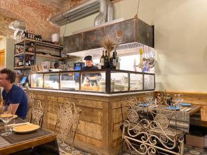 a man sitting at a counter in a restaurant at Vivaldi luxury suites in Florence