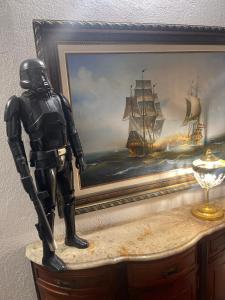 a statue of a man standing next to a painting of a ship at Rent big room with breakfast free in old city in Nancy